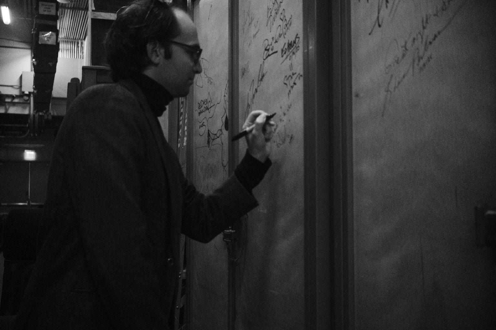 Composer Daniel Slatkin backstage signing a wall at the Hollywood Bowl